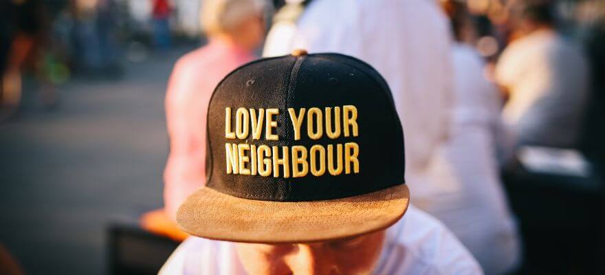 Man with cap saying love your neighbour